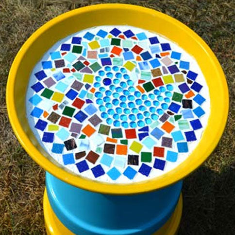 Colorful mosaic design on a yellow and blue container