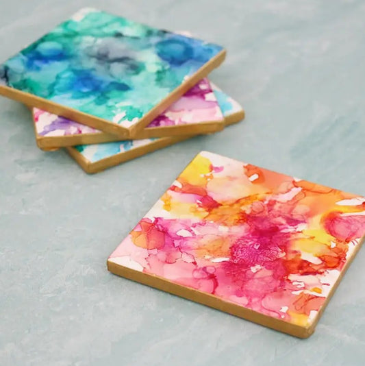 Colorful abstract art coasters on a gray surface