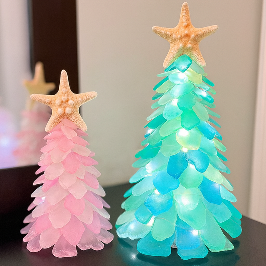 Two decorative trees with starfish on top, one pink and one blue, against a neutral background.
